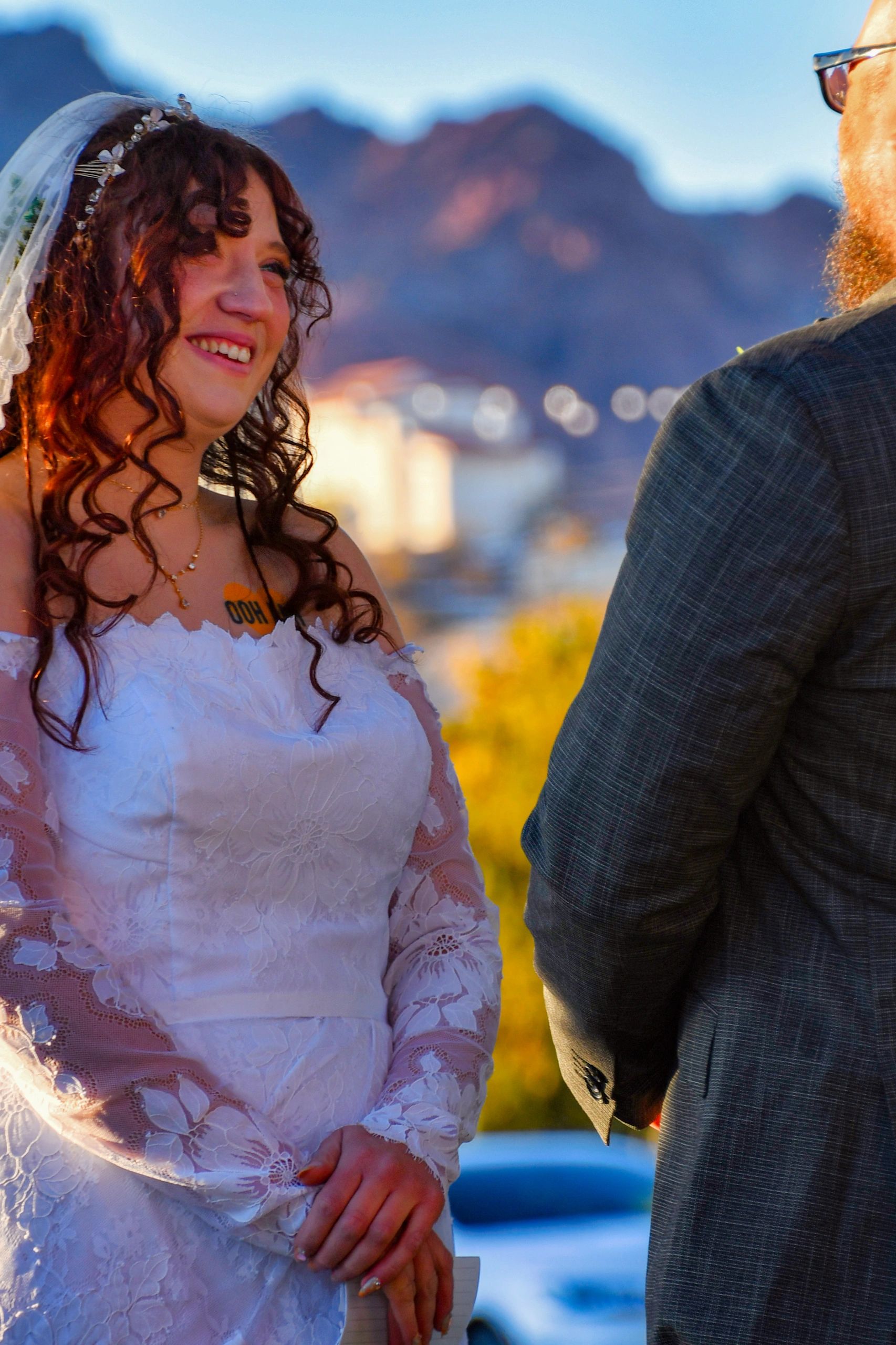 Bride and groom with mountain backdrop at golden hour