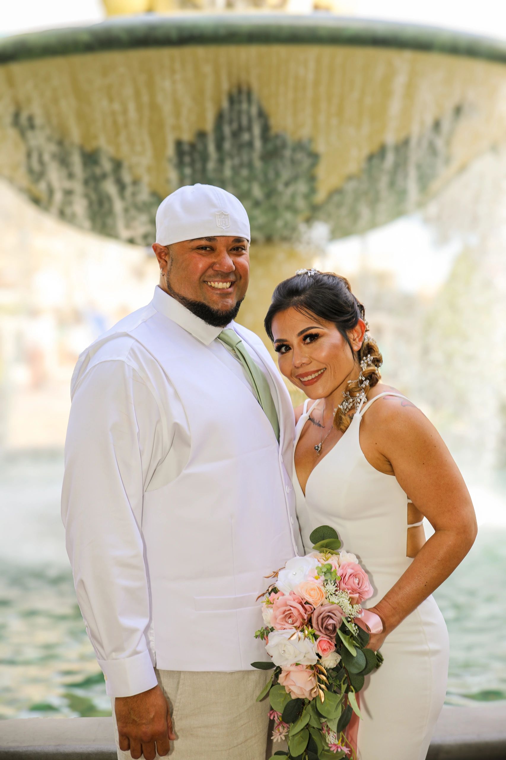 Wedding couple outdoors with ornate backdrop