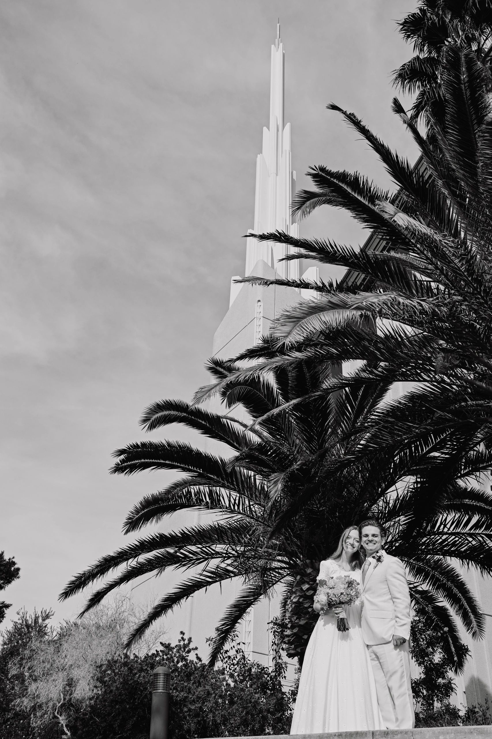 Wedding couple by palm tree and temple